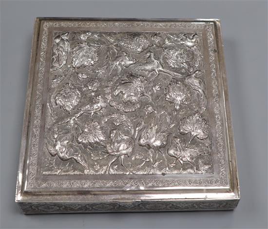 A Far Eastern white metal square box with embossed decoration of cranes and flowers